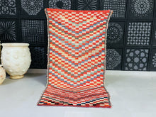 Load image into Gallery viewer, Handmade Moroccan rug with a checkerboard design in red and beige.
