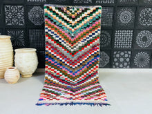 Load image into Gallery viewer, Handwoven Moroccan Boucherouite rug with colorful chevron design.
