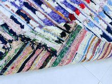 Load image into Gallery viewer, Close-up of the lively and artistic patchwork design on a Moroccan Boucherouite rug.

