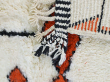 Load image into Gallery viewer, Ivory wool rug with bold orange and black patterns.

