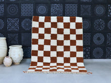 Load image into Gallery viewer, Handmade Moroccan wool rug with checkered orange and white pattern, perfect for modern and Bohemian home decor.
