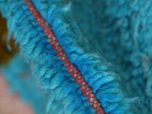 Load image into Gallery viewer, Colorful wool rug styled in a minimalist room with pastel accents.