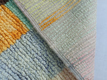 Load image into Gallery viewer, Close-up of the artistic geometric patterns on a Moroccan wool rug.