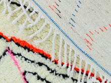 Load image into Gallery viewer, Close-up of vibrant orange, pink, and black abstract lines on Moroccan wool rug.
