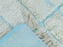 Load image into Gallery viewer, Minimalist Moroccan wool rug with a soft blue grid design.
