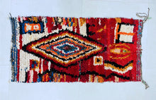 Load image into Gallery viewer, Close-up of intricate patterns on a red Moroccan rug.
