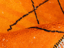 Load image into Gallery viewer, Vibrant orange Beni Ourain-style rug crafted from natural wool with tribal black lines, ideal for cozy and colorful interiors.


