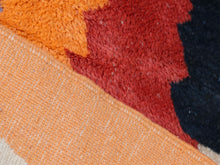 Load image into Gallery viewer, Vibrant beni ourain rug with striking tribal motifs in warm and cool tones.


