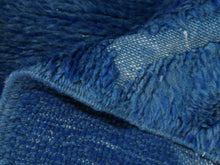 Load image into Gallery viewer, Thick wool Moroccan rug in a deep blue shade featuring hand-knotted Berber diamond symbols, crafted sustainably in Morocco.


