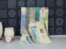 Load image into Gallery viewer, Abstract Moroccan wool rug with pastel geometric patterns displayed in a modern setting.

