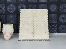 Load image into Gallery viewer, Handwoven Moroccan wool rug with cream diamond patterns and brown accents.
