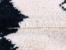 Load image into Gallery viewer, A close-up of the black and white pattern on a Moroccan Berber rug, emphasizing the handmade detail.
