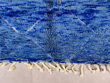 Load image into Gallery viewer, Detailed texture of a blue woolen Berber rug with white pattern highlights and dense fabric weave.
