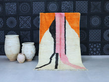 Load image into Gallery viewer, Abstract Moroccan wool rug with vibrant orange, pink, and black design.
