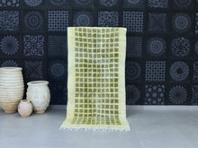 Load image into Gallery viewer, Handwoven Moroccan wool rug with a minimalist green grid design.
