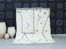 Load image into Gallery viewer, Minimalist Moroccan wool rug with black abstract geometric patterns.
