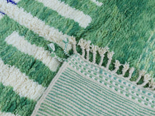 Load image into Gallery viewer, Artistic green Moroccan rug with white and blue accents.
