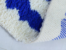 Load image into Gallery viewer, Close-up of cream and blue wool rug texture.
