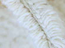 Load image into Gallery viewer, Close-up of soft cream and gold wool rug texture.
