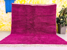 Load image into Gallery viewer, Handmade Moroccan wool rug in vibrant pink, with a plush texture and authentic Berber craftsmanship, perfect for adding warmth to a living room.
