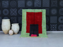 Load image into Gallery viewer, Handwoven Moroccan wool rug with bold red, green, and black geometric design.
