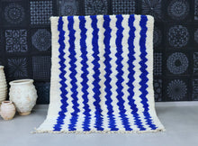 Load image into Gallery viewer, Handmade Moroccan wool rug with cream and blue wavy design.
