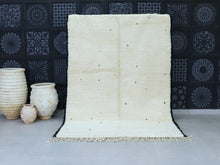 Load image into Gallery viewer, Handmade minimalist Moroccan wool rug in cream with black accents.
