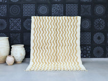 Load image into Gallery viewer, Handmade Moroccan wool rug with cream and gold wavy design.
