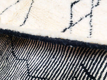 Load image into Gallery viewer, &quot;Elegant Moroccan wool rug in cream with black diamond patterns, perfect for a chic living room&quot;

