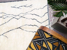 Load image into Gallery viewer, Artisanal cream Moroccan wool rug with black accents and fringe, a unique wedding gift idea

