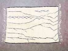 Load image into Gallery viewer, &quot;Handmade Moroccan rug with cream base and distinctive black patterns, exuding traditional elegance&quot;
