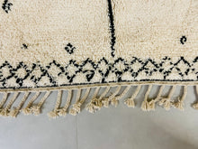 Load image into Gallery viewer, Close-up of the plush pile of a handmade Moroccan wool rug, showing the quality craftsmanship.
