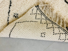 Load image into Gallery viewer, Artisanal Moroccan rug corner, highlighting the handmade tassels and the durable wool weave.
