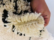 Load image into Gallery viewer, Detail of the handwoven texture of a Moroccan wool rug, emphasizing the high-quality, pure wool fibers.
